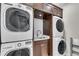 Convenient laundry room showcasing stacked washer and dryer units and a built-in sink at 212 Fernwood Pl, Woodstock, GA 30188