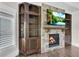 Living room features hardwood floors, stone fireplace, built-ins, and custom shutters at 212 Fernwood Pl, Woodstock, GA 30188