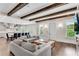 Open-concept living room with exposed wood beams and easy access to gourmet kitchen at 212 Fernwood Pl, Woodstock, GA 30188