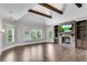 Spacious main bedroom boasts hardwood floors, a stone fireplace, and great natural light at 212 Fernwood Pl, Woodstock, GA 30188