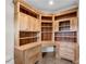 Bright office space with custom built-in wood cabinets, drawers, and shelving, ideal for organization and productivity at 212 Fernwood Pl, Woodstock, GA 30188