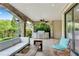Covered outdoor living space features comfortable seating and built-in outdoor kitchen area with grill at 212 Fernwood Pl, Woodstock, GA 30188