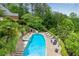 Resort-style backyard features a sparkling pool, hot tub, water slide, and a cozy lounging area at 212 Fernwood Pl, Woodstock, GA 30188