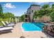 Resort-style pool area featuring chaise lounges and a tiered stone waterfall for relaxation and entertainment at 212 Fernwood Pl, Woodstock, GA 30188