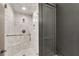 Updated marble shower features stylish fixtures, a rainfall shower head, and a built-in seat at 212 Fernwood Pl, Woodstock, GA 30188