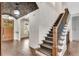Staircase featuring carpeted steps, wrought iron railings, hardwood floors, and brick ceiling at 212 Fernwood Pl, Woodstock, GA 30188