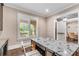 Study features a granite countertop desk space and light-filled window with shuttered blinds at 212 Fernwood Pl, Woodstock, GA 30188