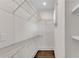 Bright walk-in closet with wire shelving and hardwood floors at 212 Fernwood Pl, Woodstock, GA 30188