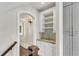 Butler's pantry with a wine rack, sink, stone counter, and elegant wall sconce at 212 Fernwood Pl, Woodstock, GA 30188