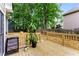 A wooden backyard deck with plants and chairs at 3285 Country Walk Dr, Powder Springs, GA 30127