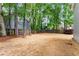 The back yard includes mature trees, a wood fence, and recent landscaping at 3285 Country Walk Dr, Powder Springs, GA 30127