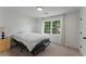 Bedroom featuring a large window, neutral walls, carpeted floors, and neutral decor at 3285 Country Walk Dr, Powder Springs, GA 30127