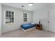 Cozy bedroom with natural light from two windows featuring neutral walls and carpeted floors at 3285 Country Walk Dr, Powder Springs, GA 30127
