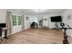 Large bonus room with multiple workspaces and large windows allowing for plenty of natural light at 3285 Country Walk Dr, Powder Springs, GA 30127