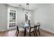 Bright dining area with modern lighting, large window, and neutral decor at 3285 Country Walk Dr, Powder Springs, GA 30127