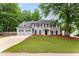 Traditional two-story home with gray siding, red shutters, two-car garage, and well-manicured lawn at 3285 Country Walk Dr, Powder Springs, GA 30127