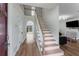 Inviting foyer featuring hardwood floors, staircase, and modern finishes at 3285 Country Walk Dr, Powder Springs, GA 30127
