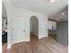 Hallway with white doors and an arched entryway leading to a kitchen area with pendant lights at 3285 Country Walk Dr, Powder Springs, GA 30127