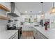 Bright updated kitchen featuring white cabinets, quartz countertops, stainless appliances, and open shelving at 3285 Country Walk Dr, Powder Springs, GA 30127