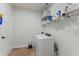 Functional laundry room equipped with shelving, a washer, and a dryer at 3285 Country Walk Dr, Powder Springs, GA 30127