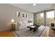 Comfortable living room with a cozy sofa, stylish decor, and large windows leading to a balcony with outside views at 3338 Peachtree Rd # Apt 403, Atlanta, GA 30326
