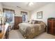 Bedroom with neutral tones, multiple windows, a queen-sized bed, and antique dressers at 3472 Honeycomb Se Dr, Conyers, GA 30094