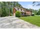 Brick two-story home featuring a long driveway and lush front lawn at 3472 Honeycomb Se Dr, Conyers, GA 30094