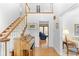 Grand foyer featuring hardwood floors, staircase, and natural light at 3472 Honeycomb Se Dr, Conyers, GA 30094