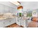 Bright kitchen with white cabinets, granite countertops, and breakfast area at 3472 Honeycomb Se Dr, Conyers, GA 30094