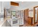 Bright kitchen featuring stainless oven, granite counters, custom cabinets, and wood flooring at 3472 Honeycomb Se Dr, Conyers, GA 30094