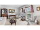 Elegant living room with neutral tones, carpet, and large windows at 3472 Honeycomb Se Dr, Conyers, GA 30094