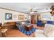 Open-concept living room with hardwood floors, wainscotting, and ceiling fan at 3472 Honeycomb Se Dr, Conyers, GA 30094