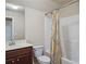 Well-lit bathroom featuring a shower-tub combo with stylish curtain and vanity with a sink and mirror at 4024 Broadmoor Sw Ct, Austell, GA 30106
