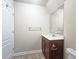 Bathroom featuring a vanity with a mirror, dark brown cabinets, and a marble countertop at 4024 Broadmoor Sw Ct, Austell, GA 30106