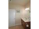 Well-lit bathroom with a double vanity, mirror and warm-toned tile floor at 4024 Broadmoor Sw Ct, Austell, GA 30106