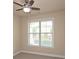 Bright bedroom featuring a ceiling fan and large window with natural light at 4024 Broadmoor Sw Ct, Austell, GA 30106