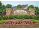 Welcome to Flint Hill Park: Beautiful brick signage surrounded by manicured landscaping and colorful flowers at 4024 Broadmoor Sw Ct, Austell, GA 30106