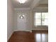 Bright entryway with hardwood floors, white door, and natural light from a large window in the adjacent room at 4024 Broadmoor Sw Ct, Austell, GA 30106