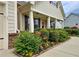 View of the home's exterior showing lush landscaping with flowering shrubs, flowers and sidewalk to front door at 4024 Broadmoor Sw Ct, Austell, GA 30106