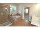 Bathroom with walk-in shower, soaking tub, and dual sinks, designed for comfort and convenience at 4024 Broadmoor Sw Ct, Austell, GA 30106