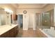 Elegant bathroom with double vanity, soaking tub, and glass-enclosed shower for a spa-like experience at 4024 Broadmoor Sw Ct, Austell, GA 30106
