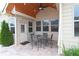 The covered patio features an outdoor dining set and provides a great space for entertaining at 4024 Broadmoor Sw Ct, Austell, GA 30106