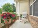 Cozy outdoor seating with a white rocking chair and potted flowers at 4024 Broadmoor Sw Ct, Austell, GA 30106