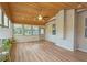 Bright sunroom featuring many windows, a ceiling fan, wood flooring, and a wooden ceiling at 4024 Broadmoor Sw Ct, Austell, GA 30106