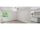 Bright bedroom featuring a ceiling fan, a view, and an attached bathroom with granite countertops at 12 Dunwoody Springs Dr # 12, Atlanta, GA 30328