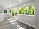 Bright dining area with large windows offering backyard views and wood-look flooring, creating a welcoming space at 12 Dunwoody Springs Dr # 12, Atlanta, GA 30328
