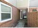 Charming brick entrance leading to the front door, offering a warm welcome with natural light from a window at 12 Dunwoody Springs Dr # 12, Atlanta, GA 30328