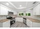 Bright kitchen with stainless steel appliances, granite countertops, and a window view at 12 Dunwoody Springs Dr # 12, Atlanta, GA 30328