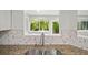 Kitchen stainless steel sink with a view to the trees and deck outside at 12 Dunwoody Springs Dr # 12, Atlanta, GA 30328