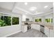 Well-lit kitchen featuring white cabinets, granite countertops, stainless steel appliances, and a view of lush greenery at 12 Dunwoody Springs Dr # 12, Atlanta, GA 30328
